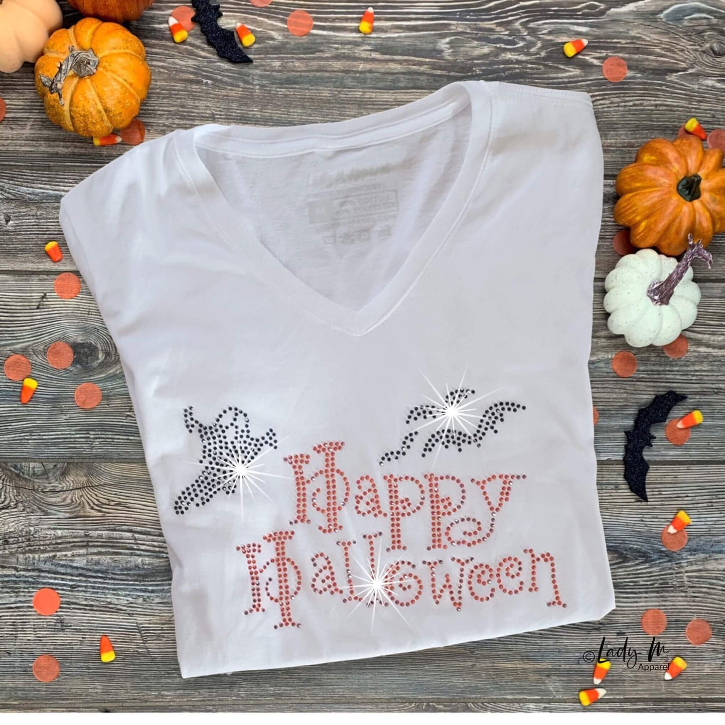 Women’s white V-neck short-sleeve t-shirt with orange and black rhinestone “Happy Halloween” design featuring bats and ghosts