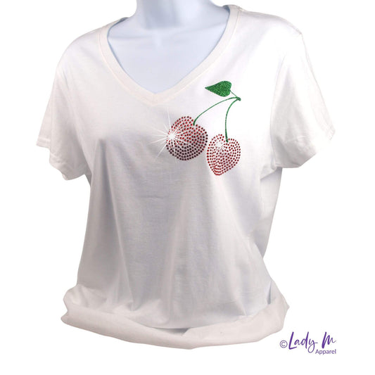 Women’s white V-neck short-sleeve tee with red rhinestone cherry design and green crystal leaf, sparkle fruit graphic top.