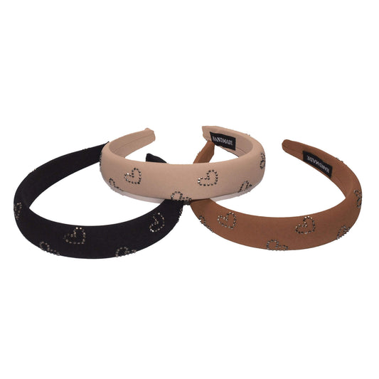 Padded headbands with rhinestone heart designs in black, nude, and camel