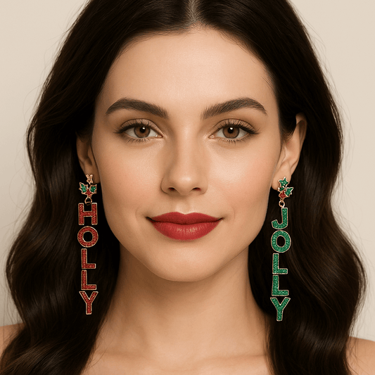 Woman wearing long dangle earrings that read “HOLLY” in red glitter and “JOLLY” in green glitter with holly berry accents for a festive holiday look.