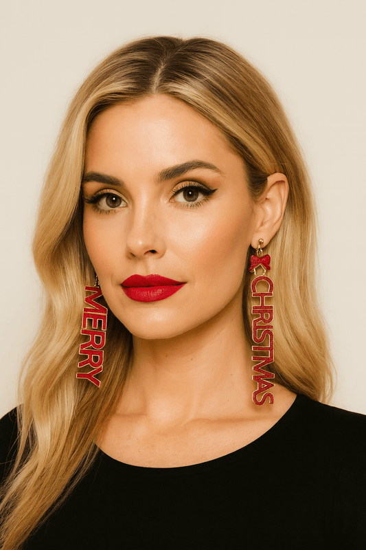 Woman wearing long red glitter dangle earrings that read “MERRY” and “CHRISTMAS” with small bow accents for a festive holiday look.