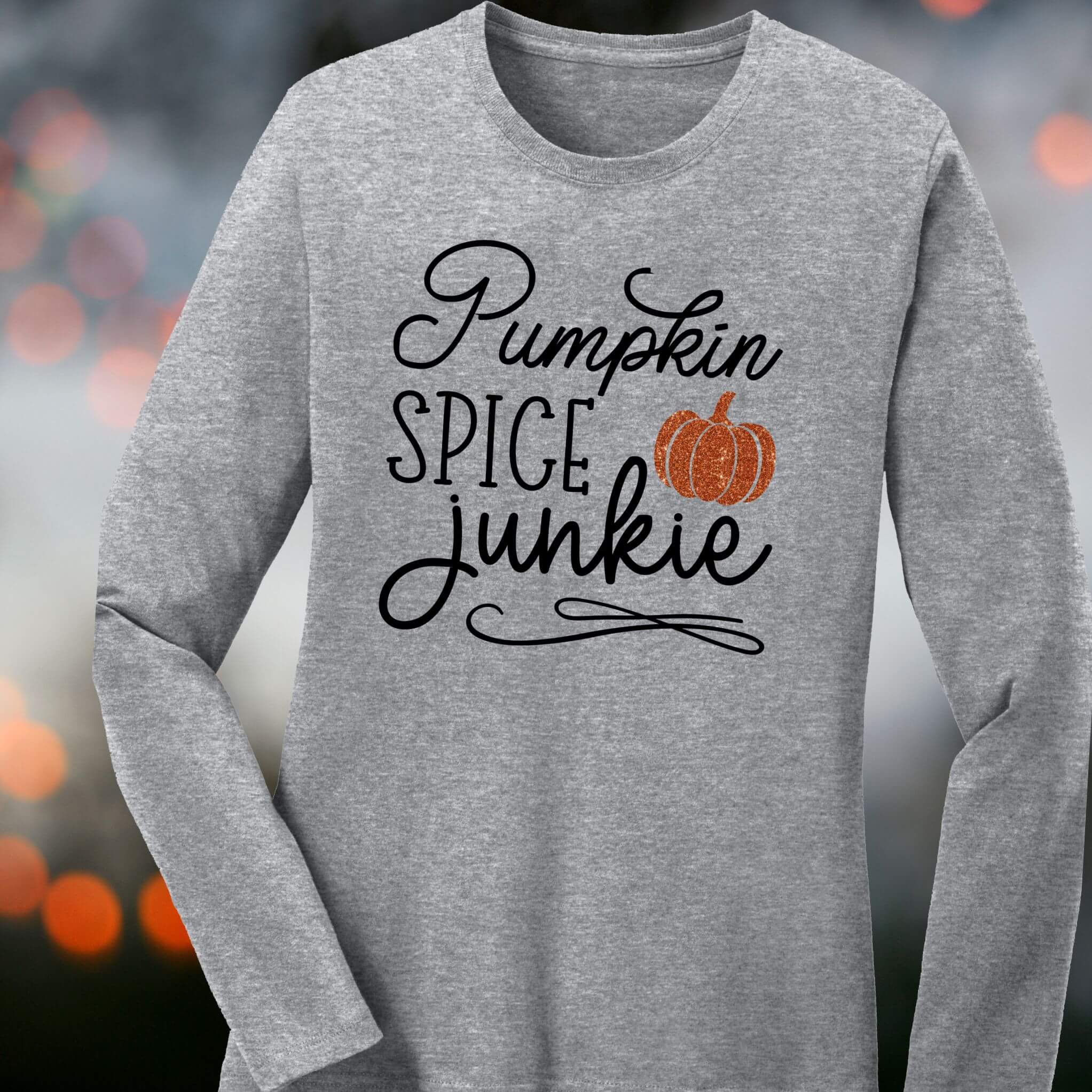 Gray long sleeve fall shirt with black script text Pumpkin Spice Junkie and glitter orange pumpkin graphic – cozy autumn coffee lover tee
