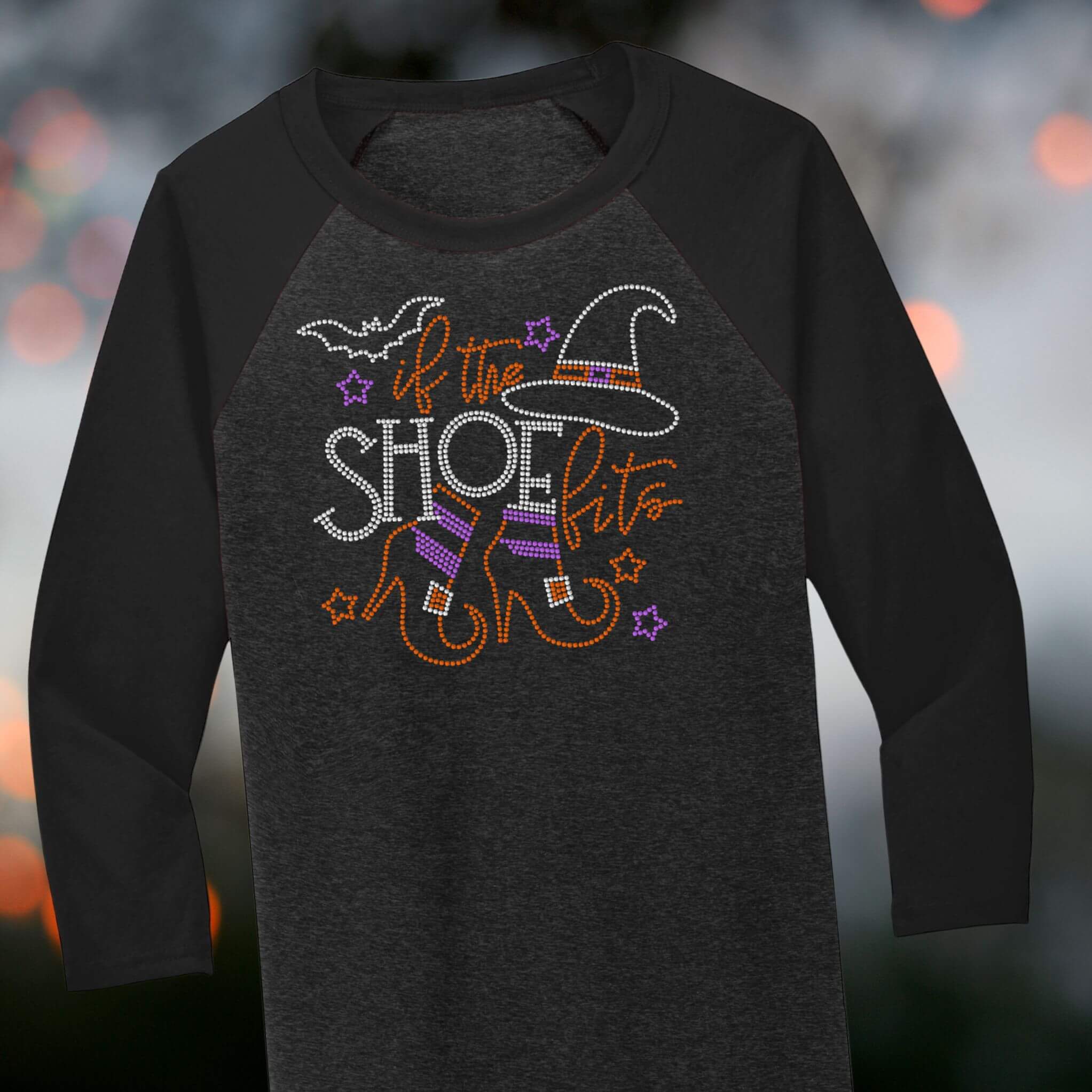 Women’s Halloween rhinestone shirt – witch hat, striped stockings, and ‘If the Shoe Fits’ design on black raglan tee.
